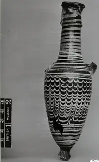 Sand-core glass vessel with a long neck, two small handles and white and dark trailed decoration