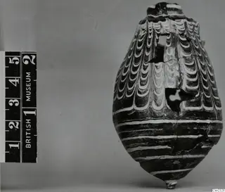 Sand-core glass vessel with white feathered and banded trails, neck broken away