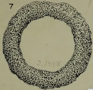 Stippled ink drawing of a ring-shaped object seen from above, on a pale card.