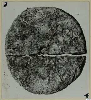 Round, flat find with a crack across its middle, from the Kastros tombs at Lapithos
