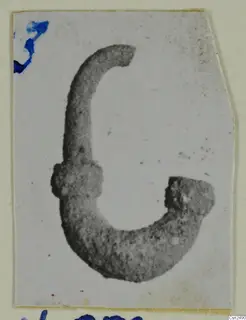 Silver object from Vouni, a curved metal piece with a knobbed end