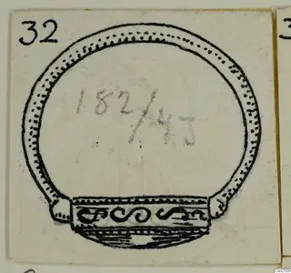 Drawing of a silver open bangle with dotted edging and a scroll-decorated wider section at one end