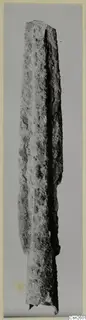 Corroded bronze weapon, a long blade, from the Amathus tombs 1–9 series, photographed upright.