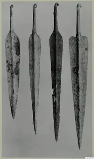 Four long metal blades with curled tangs, set side by side on a grey background