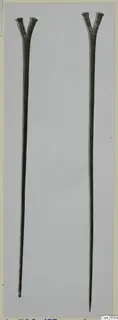 Two long bronze rods with forked, Y-shaped tops, photographed side by side on a pale grey card.
