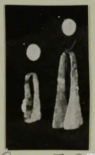 Two bronze tools photographed against a black background, each with a round number label above it.