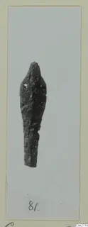 Corroded bronze tool with a small hole near its upper end, shown on a mounted card.