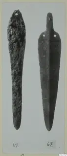 Two elongated bronze objects with perforated ends, shown side by side on a mounted card