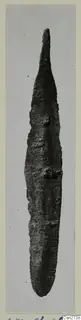 Corroded metal knife blade with a pointed tip, from Ayios Iakovos, photographed on a card mount
