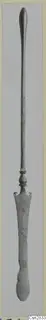 Bronze toilet implement with a long slender handle and a flat, notched blade