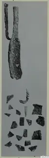 Corroded metal implement with two arms above a scatter of small fragments, bronze toilet requisites