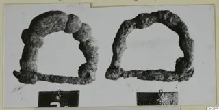 Two corroded metal arched objects with straight bars, shown side by side on a card mount.
