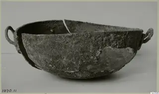 Heavily corroded bowl with two ring handles