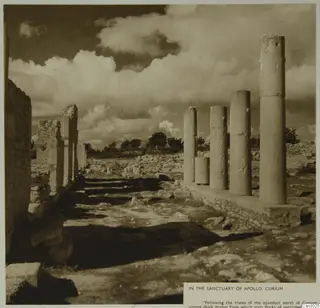 Column drums and a stone wall in the sanctuary of Apollo at Curium, under a cloudy sky