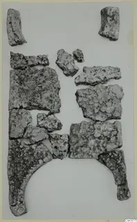 Fragments of a bronze ingot from Mathiati, laid out on a pale surface