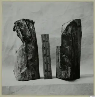 Two pieces of ancient timber side by side, used on the left and unused on the right, with a ruler between them.