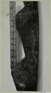 Dark wooden object with a curved notch, photographed beside a metal measuring rule, from the Cypriote Mining group