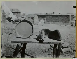 Clay dish and clay windbreak for an outdoor fire on a rough wooden table at Klirou village