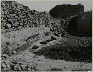 Donkey feeding place at Gallinoporni: stone troughs cut into a rock ledge beside a dry-stone wall