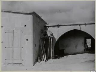 Dovecote at Galinoporni: a stone building with a wooden double door and a large arched vault