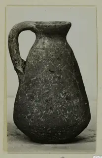 Small jug with a single strap handle, Pottery Plain White IV-V, photographed on a plain background.