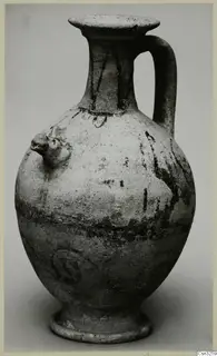 White Painted jug with a single strap handle, a knob on one side and dark painted bands, on a grey background