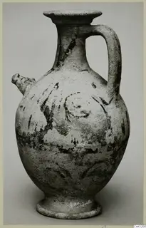 White Painted pottery jug with a side spout, strap handle and dark painted bands and spiral motifs