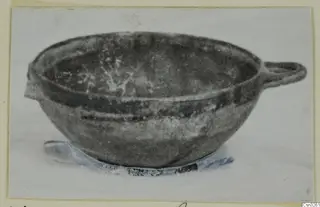 Pottery White Painted VI bowl with a side handle and a small lug, shown on a pale base
