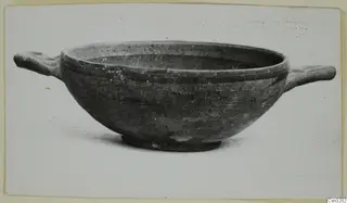 Pottery bowl with two short horizontal handles and a low ring foot, shown in profile