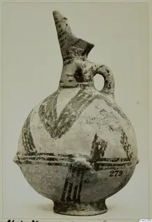 White Painted pottery juglet with a tall spout, loop handle and dark painted bands and chevrons