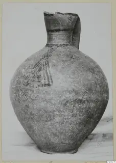 Pottery White Painted III-1 jug with a tall neck, strap handle, painted bands and a motif on the body