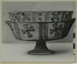 White Painted III-1 footed bowl with dark painted geometric bands and pinwheel motifs