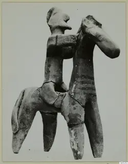 Terracotta figurine of a human figure seated on the back of a four-legged animal, from Ayia Irini