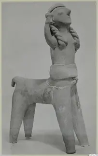 Terracotta figurine with a four-legged animal body and a human-like upper body, one arm raised to the head.