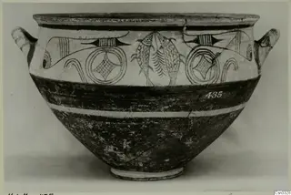 White Painted pottery bowl with two handles, painted fish and circle motifs in dark paint on a pale upper band