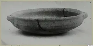Shallow pottery bowl with two small lug handles and a crack, from Amathus tombs 1–9