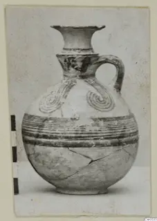 White Painted IV pottery juglet with a flared neck, single handle and spiral and banded painted decoration