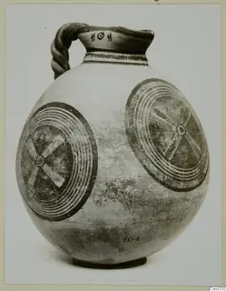 White Painted IV vessel with a twisted strap handle and two large concentric circle motifs on its body
