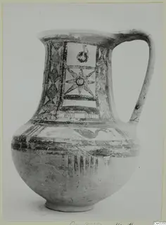 Bichrome wheel-made jug with a strap handle, painted with star and panel motifs on the neck and shoulder