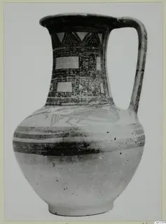 Wheel-made bichrome jug with painted bands and geometric patterns on the neck