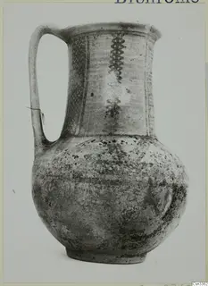 Wheel-made painted jug with a strap handle and banded decoration on the neck and shoulder