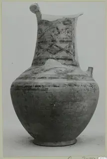 Bichrome pottery jug, wheel-made, with painted bands and rosette motifs on the neck.
