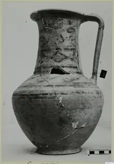 Bichrome wheel-made jug with a strap handle and dark painted bands and motifs