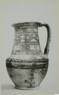 Wheel-made bichrome jug with a single handle and painted geometric bands