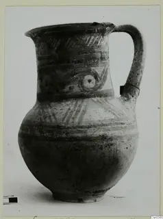 Painted jug with a loop handle, horizontal bands, hatched motifs and concentric circles on the neck