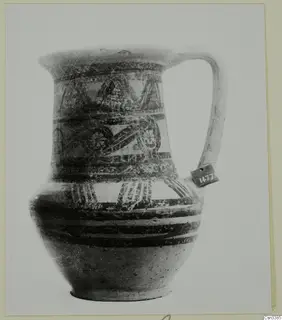 Bichrome wheel-made pottery jug with a single handle and painted bands