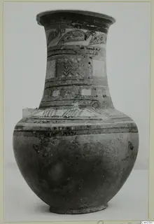 Tall wheel-made pottery jar with painted bands and motifs on its neck and shoulder