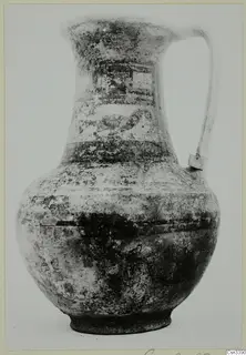 Bichrome wheel-made jug with a single strap handle and painted bands on the neck and shoulder