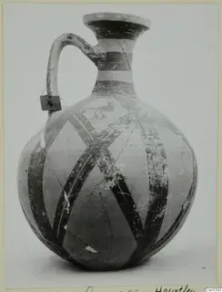 Jug with a loop handle and dark painted bands and diagonal stripes, from Milia.