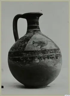 Painted jug with a single handle, banded neck and a triangular panel on the shoulder with a dark bird-like motif